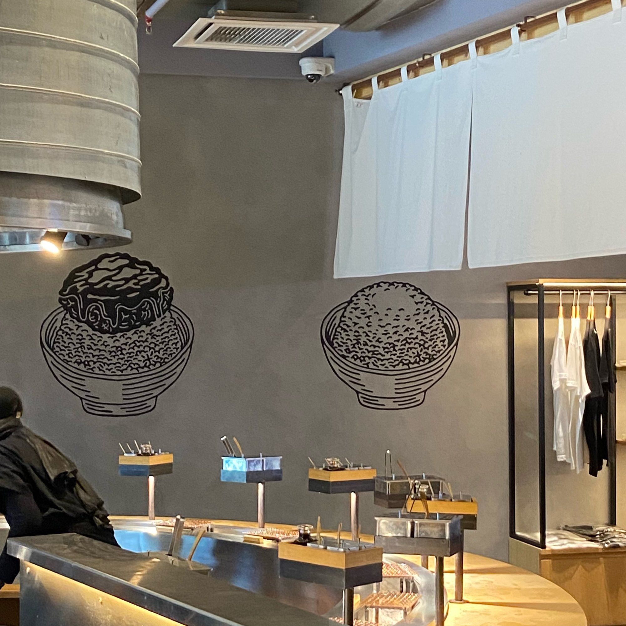 Hikiniku To Come restaurant at Sunway Pyramid, grey textured walls with line drawings above the counter